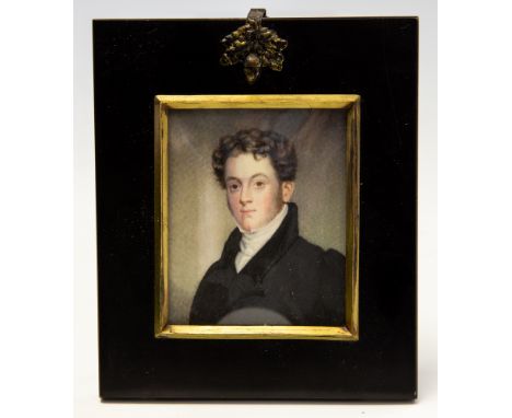 A mid 19th Century portrait miniature on ivory, circa 1850, a young gentleman, bust length wearing a white stock and black ja