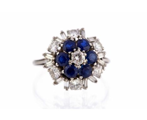 A diamond and sapphire three tier white gold cluster ring, the three tiers comprising seven round brilliant-cut diamond and s