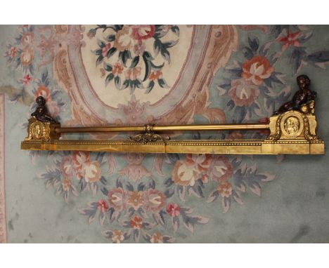 A 19th Century brass extending fender, bronzed cherub end finials over oval portrait medallions dated '1776', length closed 1
