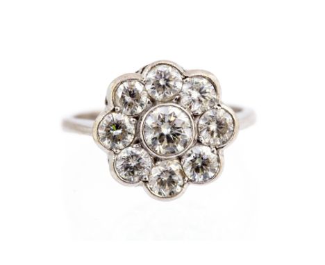 A diamond flower head cluster 18ct white gold ring, the cluster rubover set with a total of nine round brilliant cut diamonds