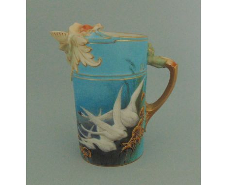 A Royal Worcester lion headed  water jug, blue ground painted with swans, signed C. Baldwyn, No.1258, circa 1899, 14cm highCo