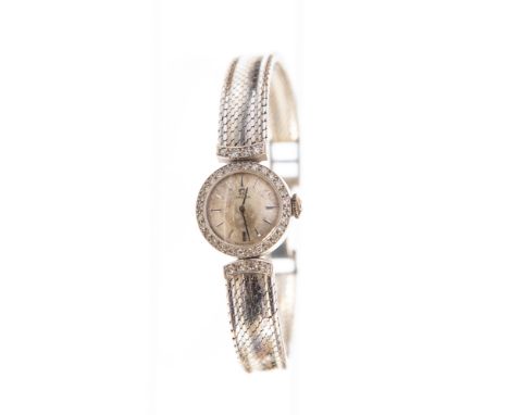 Omega, a circa 1960's lady's 18ct white gold Omega wristwatch, 1.5cm circular dial with a diamond set bezel and strap shoulde
