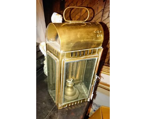 A Victorian brass railway lamp, the domed top with ring handle, stamped LYR, three glazed sides enclosing oil lamp, approx 34