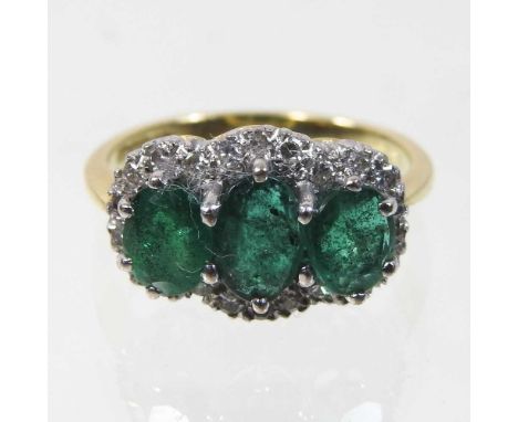 An 18 carat gold emerald and diamond triple cluster ring, size M, boxed, 4.4g gross weightCondition report: Looks to be compl