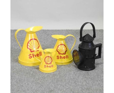 A set of three Shell advertising jugs, together with a vintage style railway lamp, 39cm high