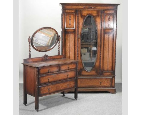 A 1920's oak Jacobean style single wardrobe, 128cm, together with a matching dressing tableCondition report: Wardrobe - 129w 