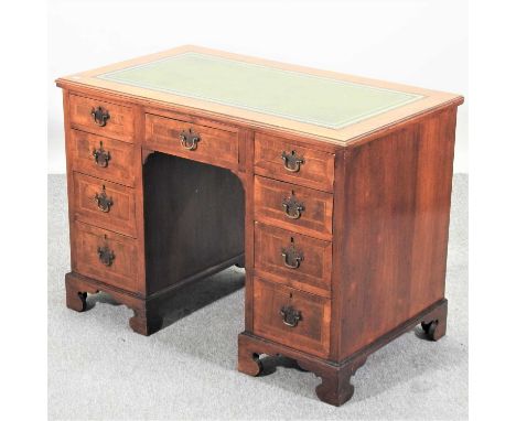 An early 20th century walnut pedestal desk, of small proportions, with an inset writing surface107w x 61d x 76h cmCondition r