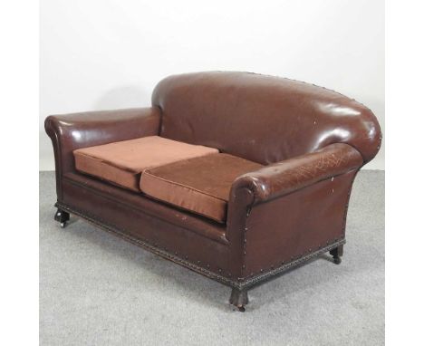 A 1920's brown upholstered sofa, with studded decoration152w x 81d x 73h cm