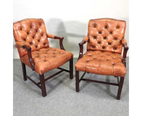 A pair of leather upholstered button back open armchairs, of Georgian style, on square legs