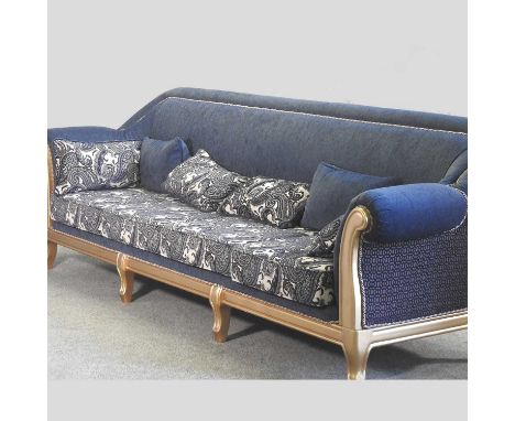 A large gilt framed blue upholstered sofa, with floral upholstered cushion280w x 82d x 96h cm