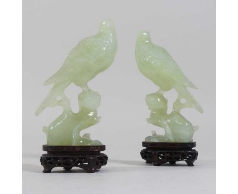 A pair of oriental carved jade coloured stone birds, each on a stand, 16cm highCondition report: These look to date from the 