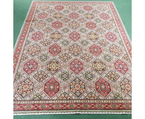 An Axminster style carpet, with an all over lozenge pattern, on a cream ground, 350 x 280cmCondition report: It looks to be c