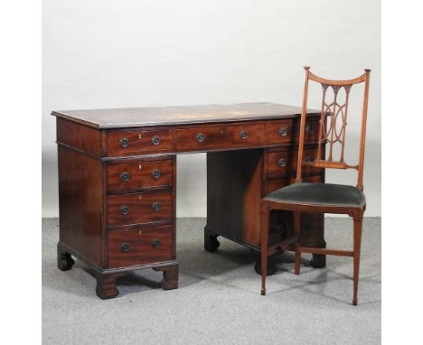 A late Victorian mahogany pedestal desk, by Jas Shoolbred &amp; Co., with an inset leather writing surface, on bracket feet, 