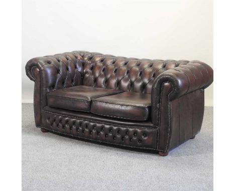 A brown leather upholstered chesterfield sofa, with a buttoned back161w x 90d x 73h cm