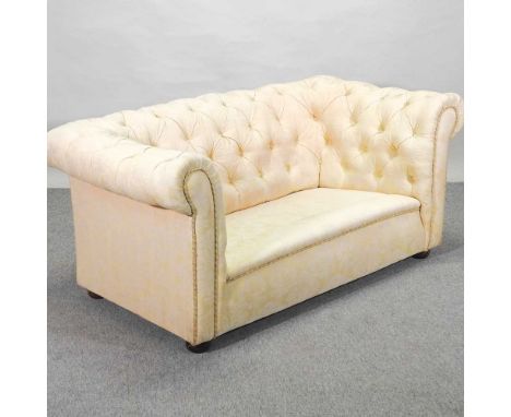 A 1920's cream upholstered chesterfield sofa162w x 89d x 70h cm