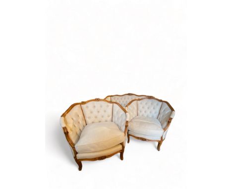 A Louis XV style stained beech carved three-piece bergere salon suite
Comprising a sofa and a pair of bergere chairs, upholst