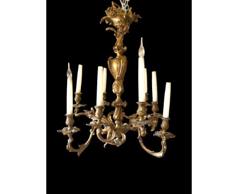 A late 19th/early 20th century gilt bronze eight light chandelier in the Louis XV style
With scrolling leaves, cabochon cast 