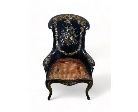 A mid Victorian papier m&acirc;ch&eacute; armchair 
Decorated with mother of pearl and gilt highlights, the shaped back with 