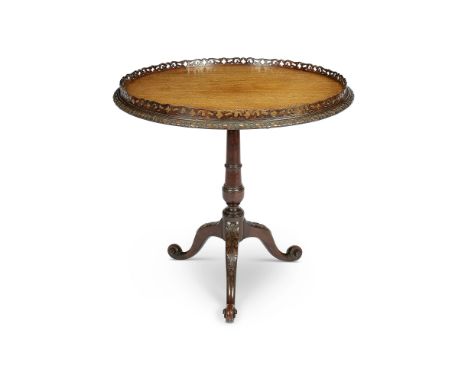 A late 19th century carved mahogany tripod table in the Chippendale style
The circular tilt-top with pierced gallery and pate