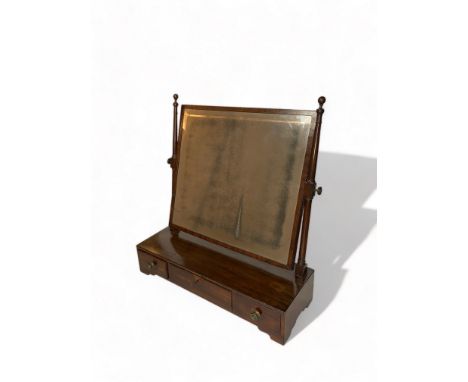 A large Regency mahogany toilet mirror
The rectangular bevelled swing plate above a rectangular top and three drawers on brac