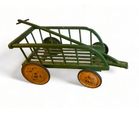 A vintage green painted wooden child's cart
With pull along handle, the cart itself 67cm wide, 39cm deep, 34cm high.