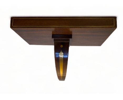 A George IV mahogany and brass inlaid clock wall bracket
The rectangular shelf with a curved support, 31cm wide, 19cm deep, 2