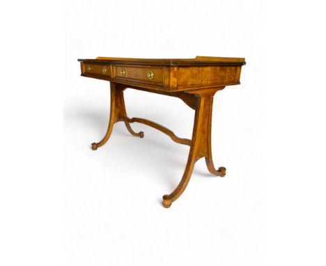 A Regency style ash sofa table by Baker Furniture
The rectangular crossbanded top with gallery and reeded edges above two fri