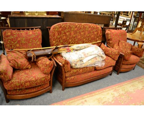 An Ercol three piece suite, with additional covers