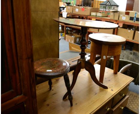 A tripod table, two stools and two chairs