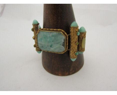 A highly ornate and costume jewellery bracelet with jade effect panel 