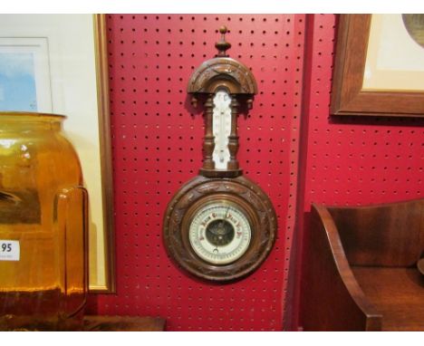 An Edwardian heavily carved barometer with mercury thermometer 