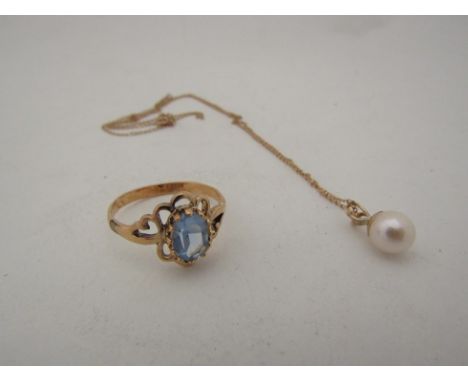 A costume ring set with pale blue stone and a single pearl pendant hung on chain, stamped 9ct 