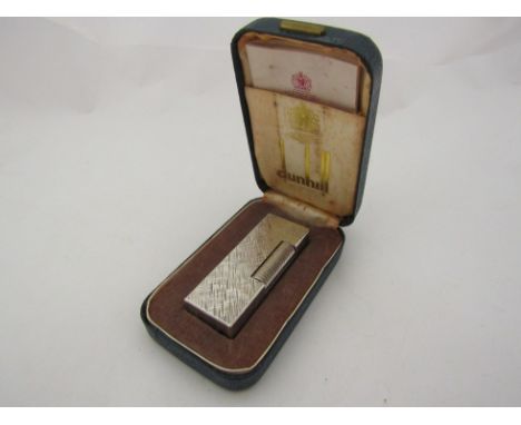 A Dunhill white metal cigarette lighter with crosshatch design, cased 