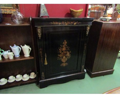 An early 19th Century ebonised and walnut pier cabinet with urn and floral marquetry exotic wood inlay having gilt ormolu dec