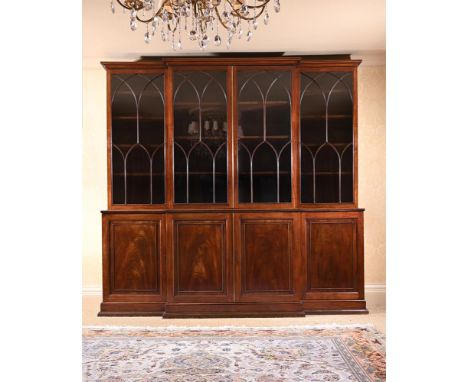 A MAHOGANY BREAKFRONT LIBRARY BOOKCASE IN GEORGE III STYLE  19TH CENTURY Of breakfront outline, the lancet moulded glazed doo