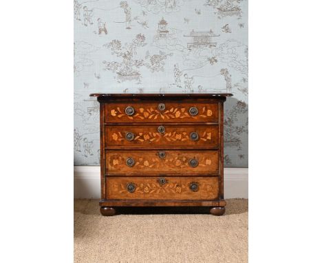 A DUTCH WALNUT AND MARQUETRY COMMODE  EARLY 18TH CENTURY AND LATER The shaped top with central flowering urn above an arrange