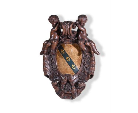 A CARVED OAK ARMORIAL PANEL IN THE BAROQUE TASTE  19TH CENTURY  The cartouche form panel scumbled to simulate ash and with a 