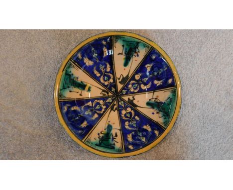 A Persian glazed ceramic dish in blue glaze, dated and marked to base. 8x27cm