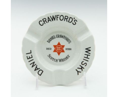 Glazed white, hand-decorated stoneware.Advertising ware produced for DANIEL CRAWFORD'S RED STAR SCOTCH WHISKY. Scalloped rim.