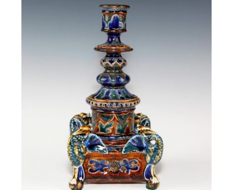 Glazed earthenware with four heron statuary base, profuse flora.A Doulton Lambeth candlestick with extensive floral decoratio