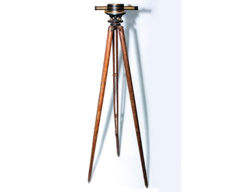 Brass and iron construction, bubble level, wooden tripod.Mounted surveyors or engineers scope with incremental adjustment poi