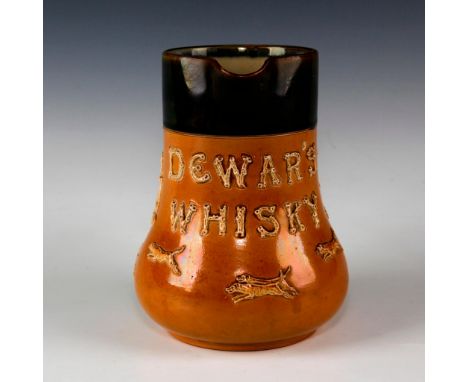 Salt glazed Art Nouveau pitcher with raised relief decoration.Dark and light brown salt glaze pitcher with raised decorations