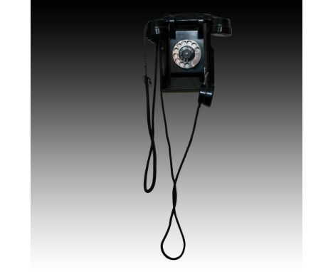 Rotary dialer, striking jet black, sleek Mid Century design.Black Bakelite with evocative dialer and number. Faux spit cup mo