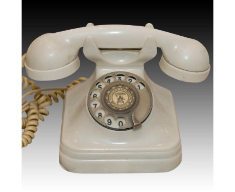 White Bakelite rotary telephone. Original coiled rubber cord.A vintage L.M. Ericsson white Bakelite rotary telephone stamped 