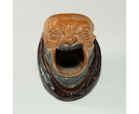 Art Nouveau glazed stoneware with extensive detail.A rare Doulton Lambeth shaving mug, modeled as a laughing monk with open m