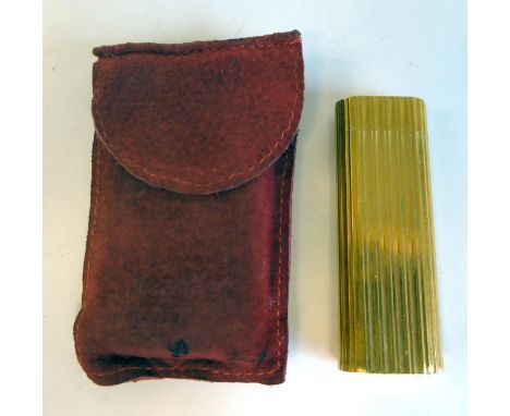 A Cartier gold plated, cased, gas filled cigarette lighter of oval, reeded form&nbsp; No.53809T, in a fabric pouch 