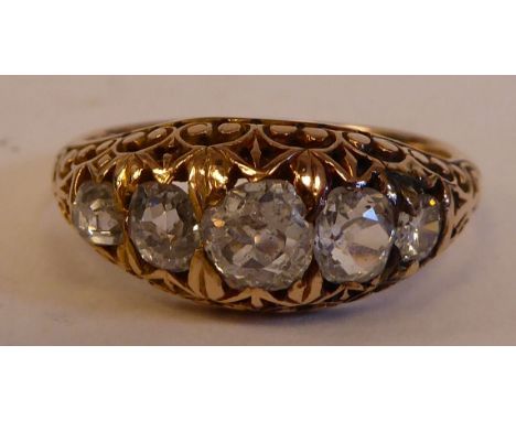 A Victorian gold and black enamel, blue diamond ring, set with five graduated stones, on scrolled shoulders 
