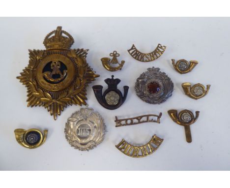 Eleven military Light Infantry metal badges, some copies; and a Durham light Infantry metal helmet plate (Please Note: this l