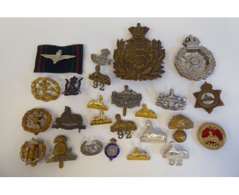 Approximately twenty-five military metal helmet plates and badges, some copies: to include Indian Army (Please Note: this lot