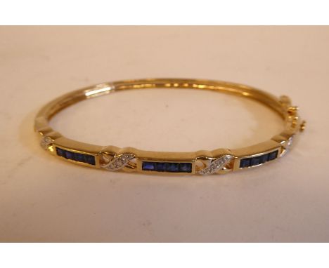 A 9ct gold sapphire and diamond set, hinged bangle 